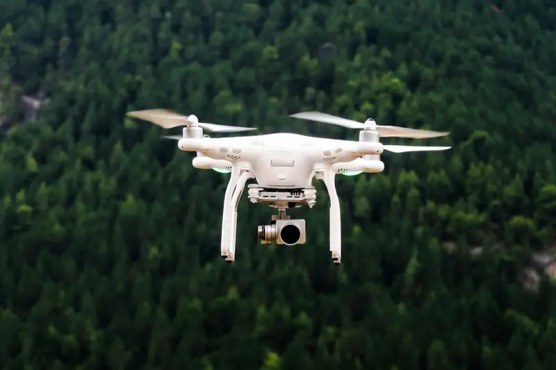 Survey drone in flight above a forested site
