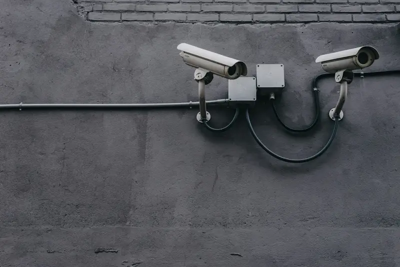 Bank of CCTV cameras mounted on a concrete wall